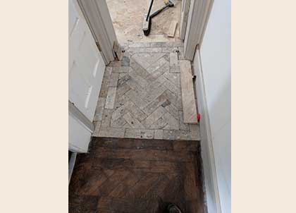 The original parquet with the old finish, leading on to the restored blocks and new parquet floor